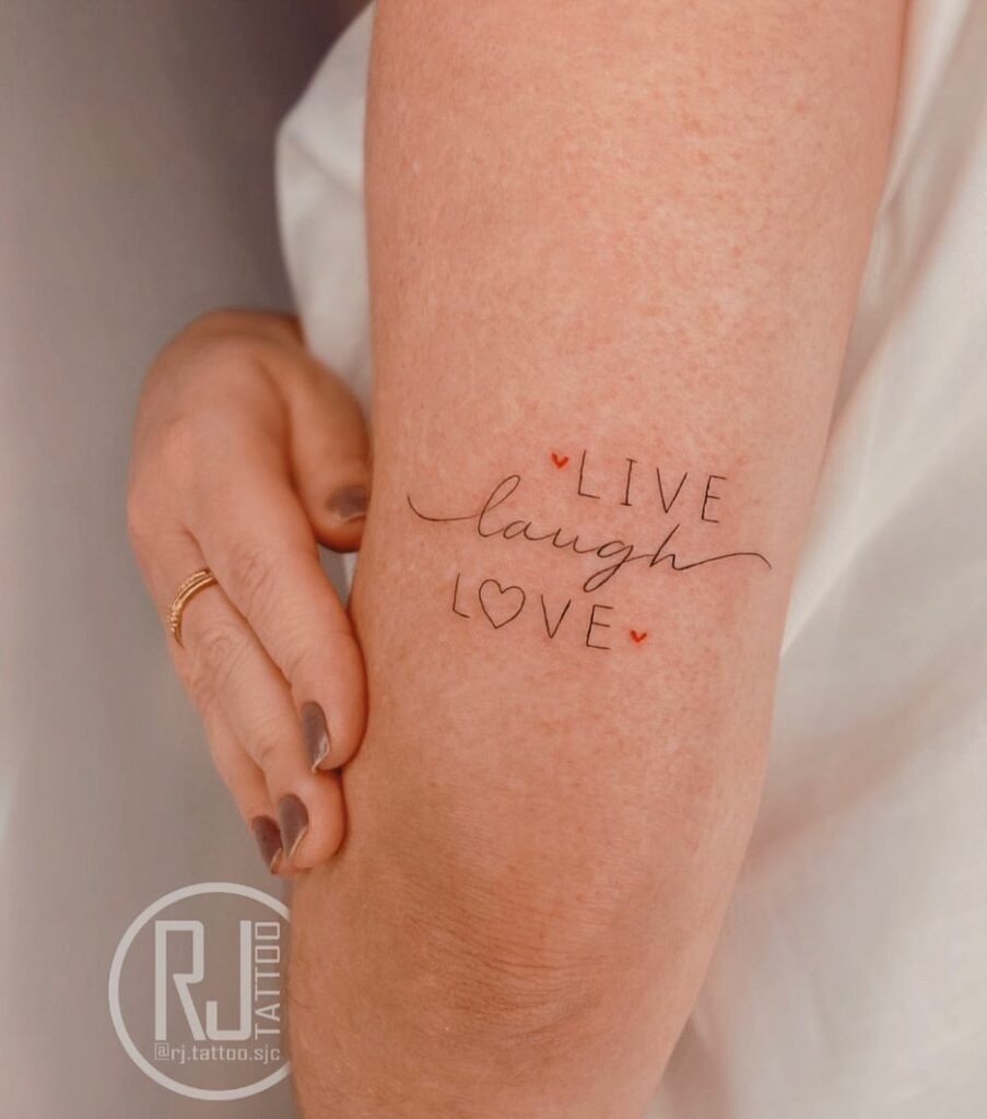 Live laugh love vertically aligned above elbow tattoos for females