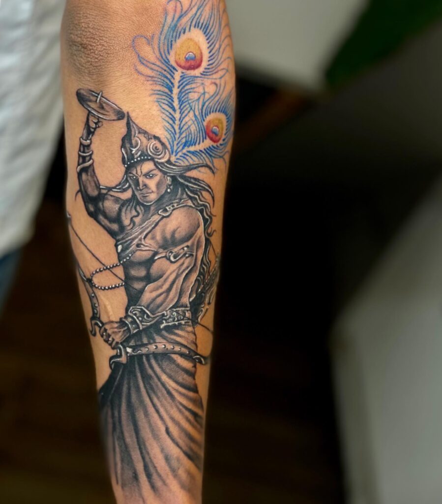 Lord Krishna with Peacock Feather Tattoo on Arm Divine Symbolism
