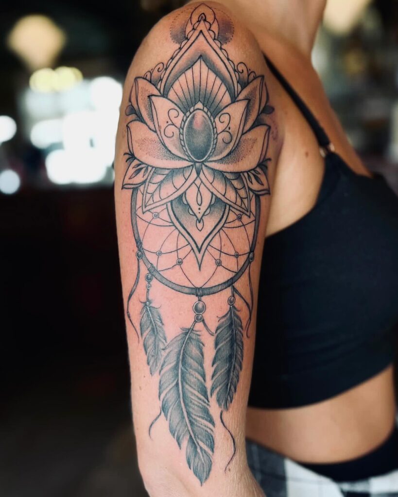 Lotus dreams dreamcatcher tattoo on the upper arm