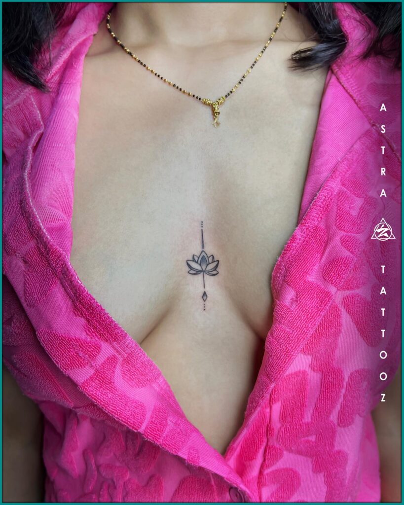 Lotus flower sternum tattoo with subtle ornamental and spiritual details