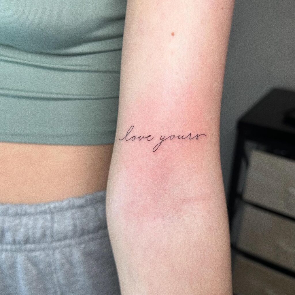 Love Yours Script Lettering Tattoo Above the Elbow, a Message Close to the Heart: Cherished Reminder