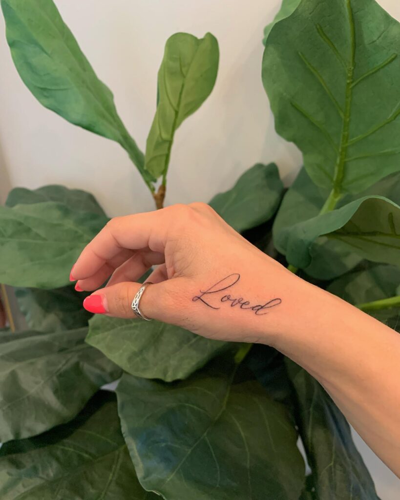 Loved text lettering tattoo on the hand for females a beautiful reminder