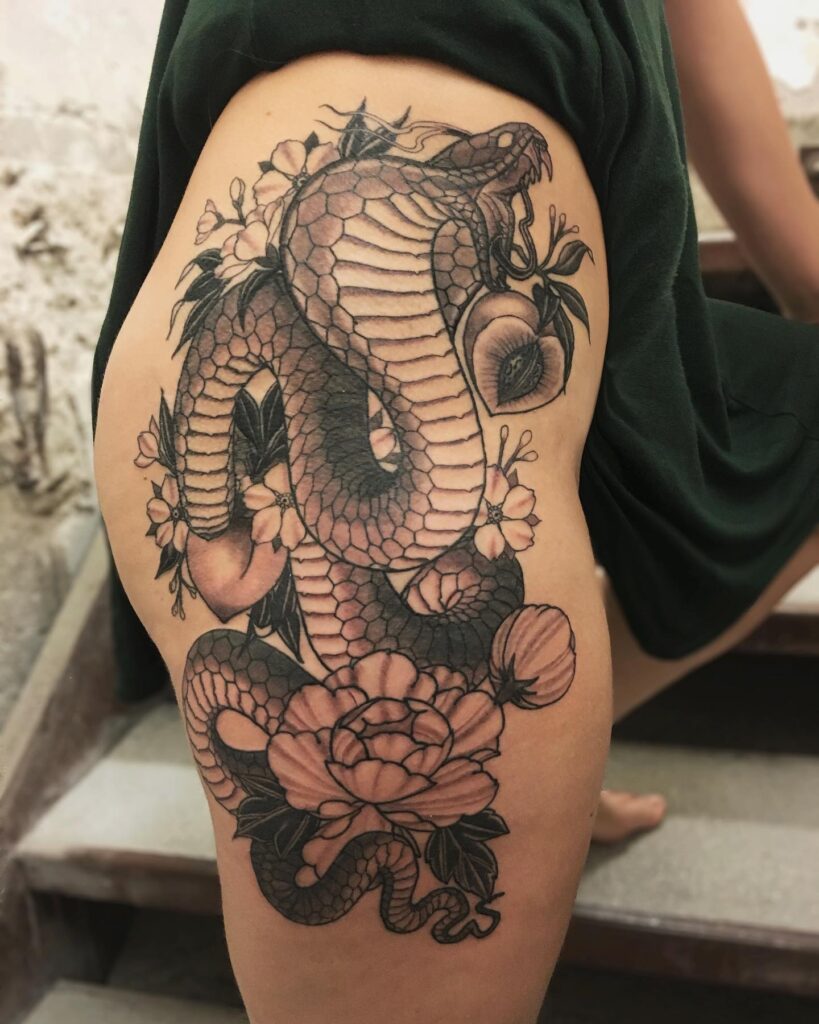 Lovely hip and thigh tattoo with flowers entwined: cobra blossoms