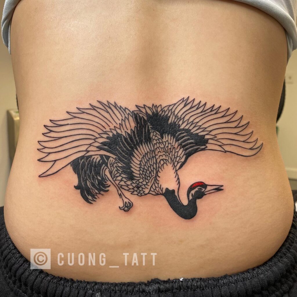 Lower Back Tattoo with Open Wings in Black and Grey: Crane's Grace