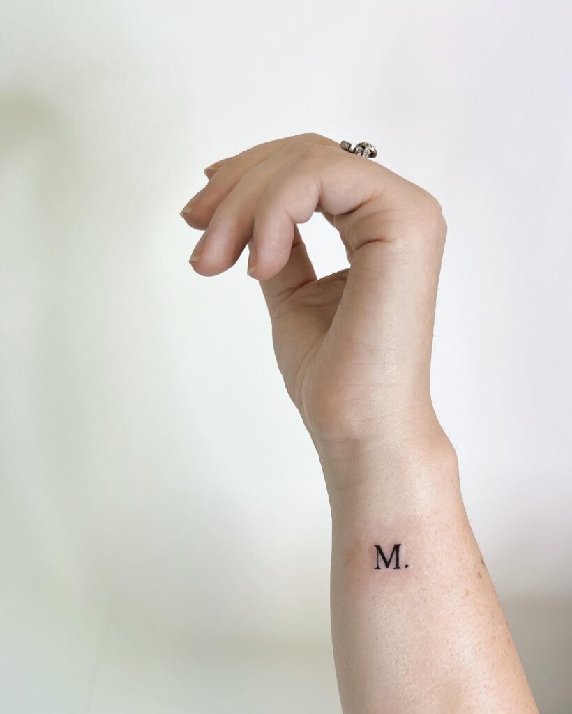 'M.' Text on the Side of the Wrist Tattoo: Stylish Statement, Adding Flair