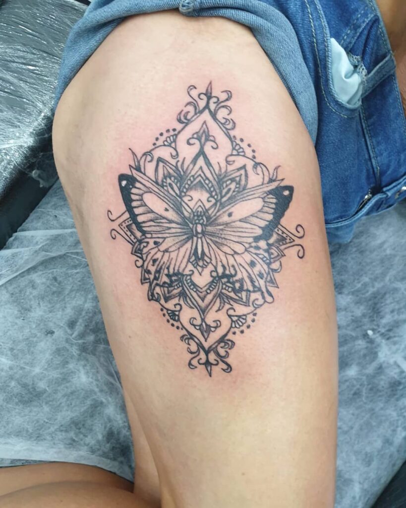 Mandala magic butterfly tattoo on the thigh