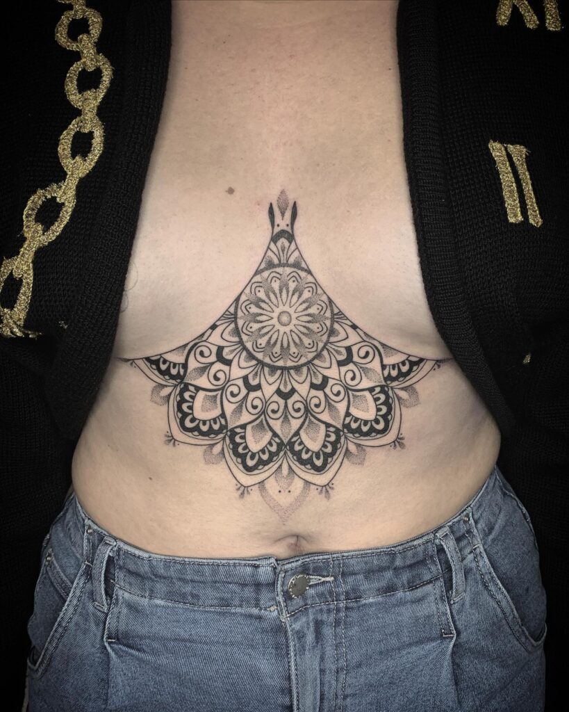 Mandala sternum tattoo with geometric symmetry and meditation symbolism