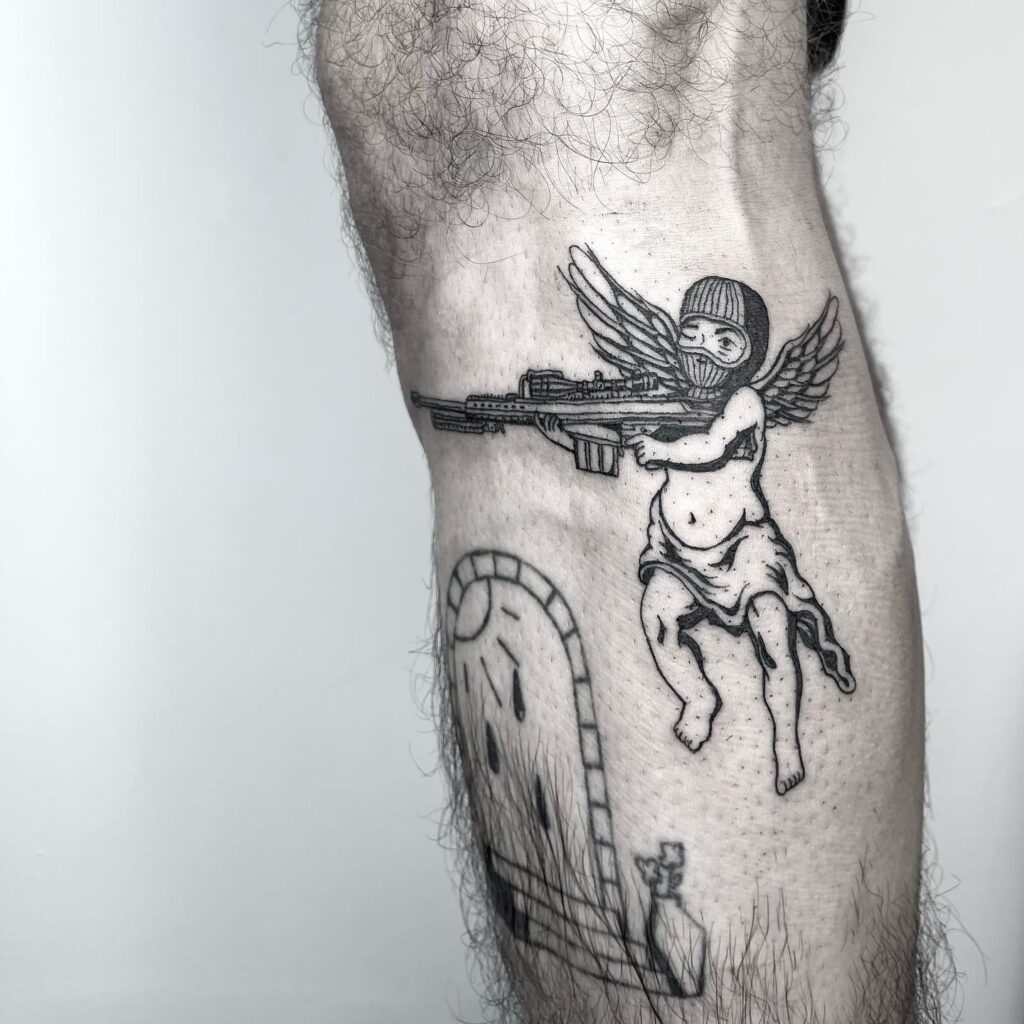 Masked angel with gun tattoo with image