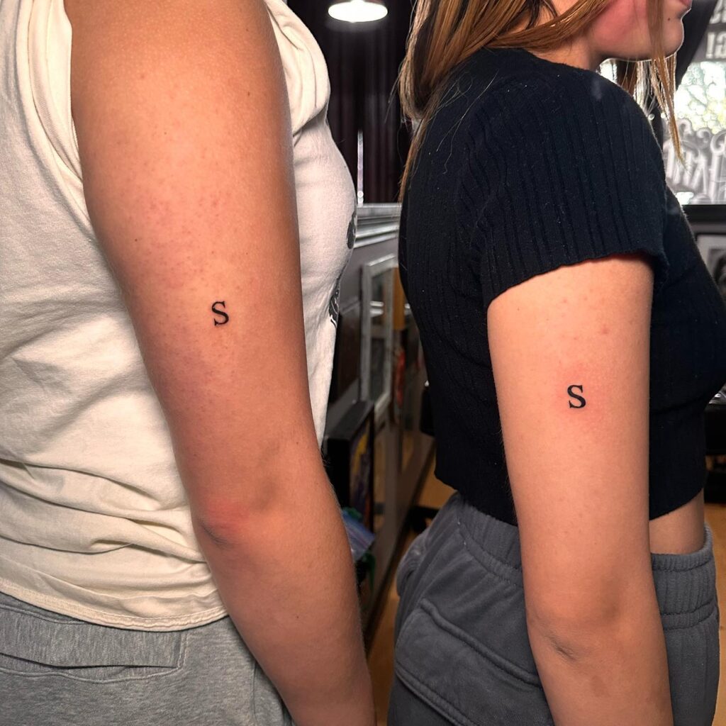 Matching 'S' Letter Tattoos on the Arms: Friendship Tokens