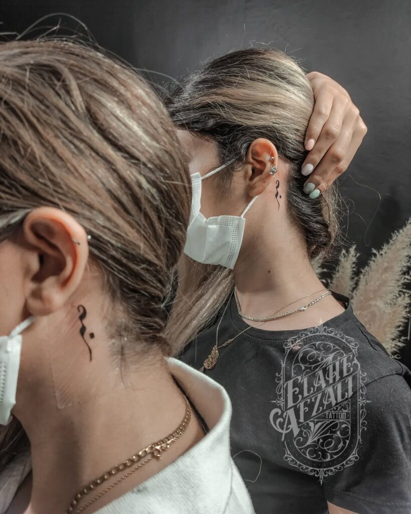 Matching Bass Clef Tattoos Behind Ear Musical Symbolism and Harmony