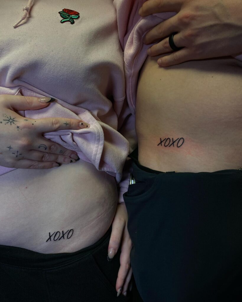 Matching Couple 'XOXO' Text Lettering Tattoo on the Hip, a Symbol of Affection: Whispers of Love
