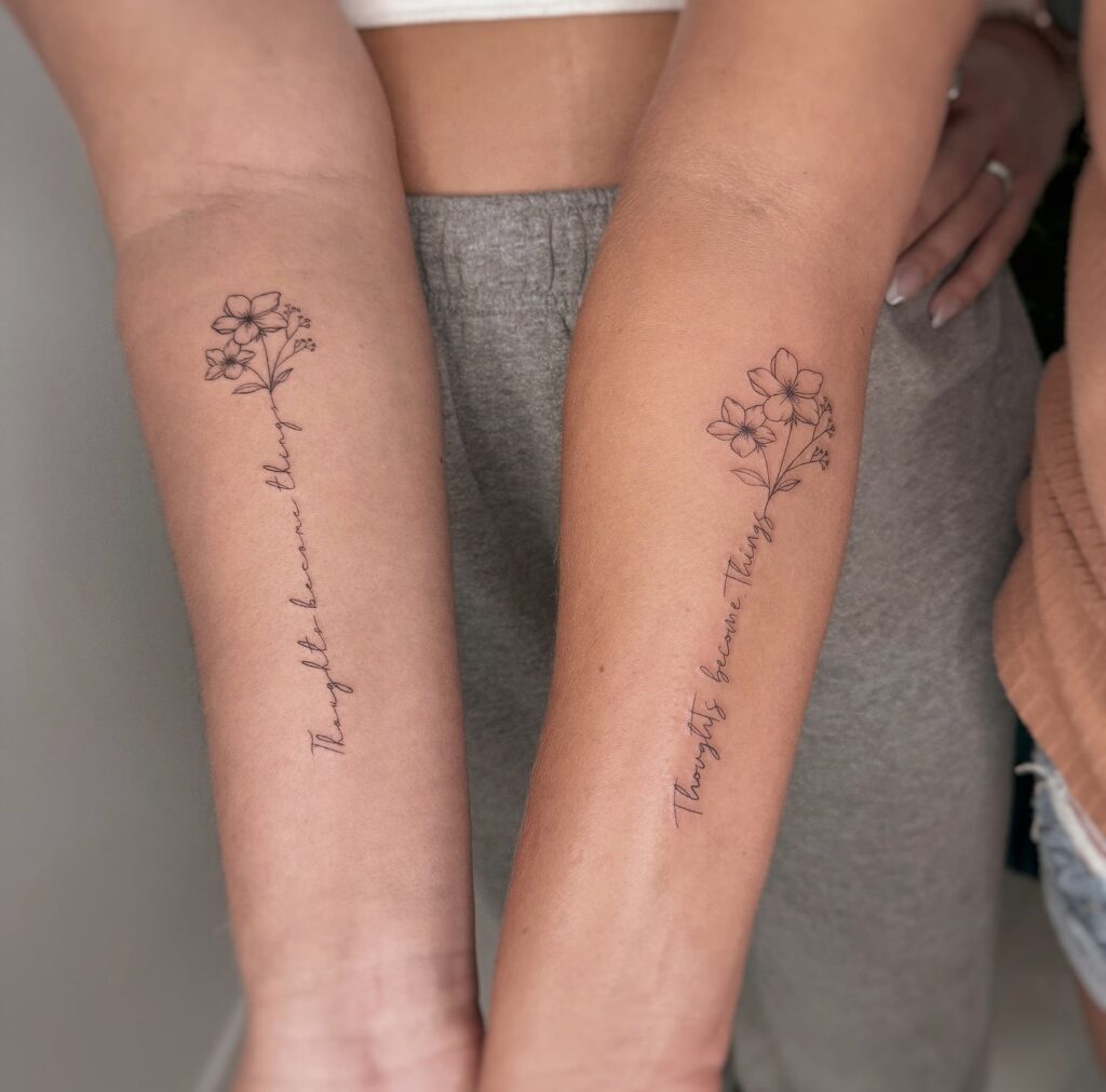 Matching floral quote tattoos with "Thoughts become Things" message