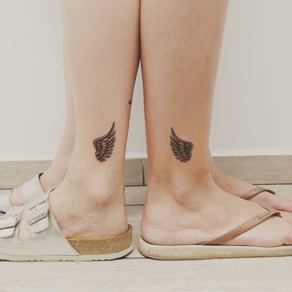 Matching Half Wing Tattoos on the Above the Ankle, Symbolizing Unity: Sisterly Soar