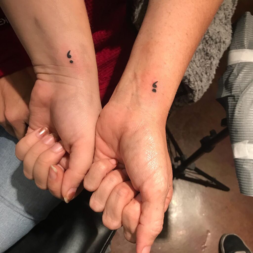 Matching Semicolon Tattoos on Inner Wrists: Couple's Commitment