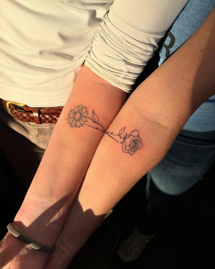 Meaningful mother-daughter tattoo with sunflower and rose design
