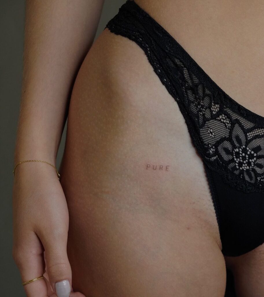 Meaningful 'Pure' Text Hip Bone Tattoo: Pure Hip Elegance