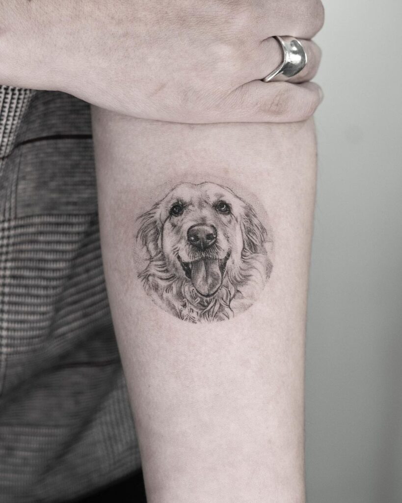 Medium-sized grey dog face portrait tattoo on the forearm pet's gaze
