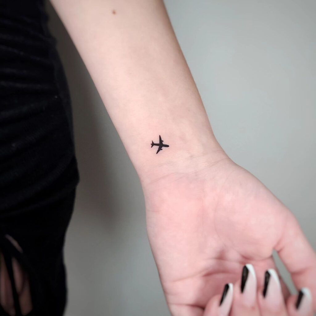 Micro Airplane Tattoo on the Inner Wrist, a Subtle Adventure: Skybound Dreams