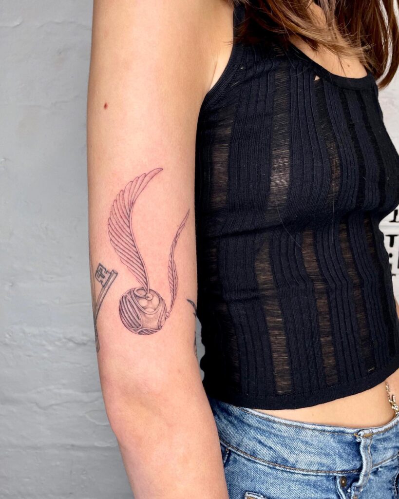 Micro-realism meets fantasy the inner arm golden snitch tattoo