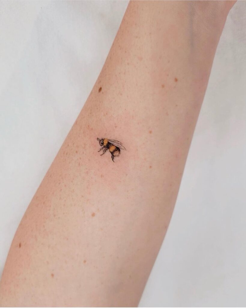 Micro-Realistic Colorful Bee Tattoo on the Inner Forearm: Buzzing Beauty