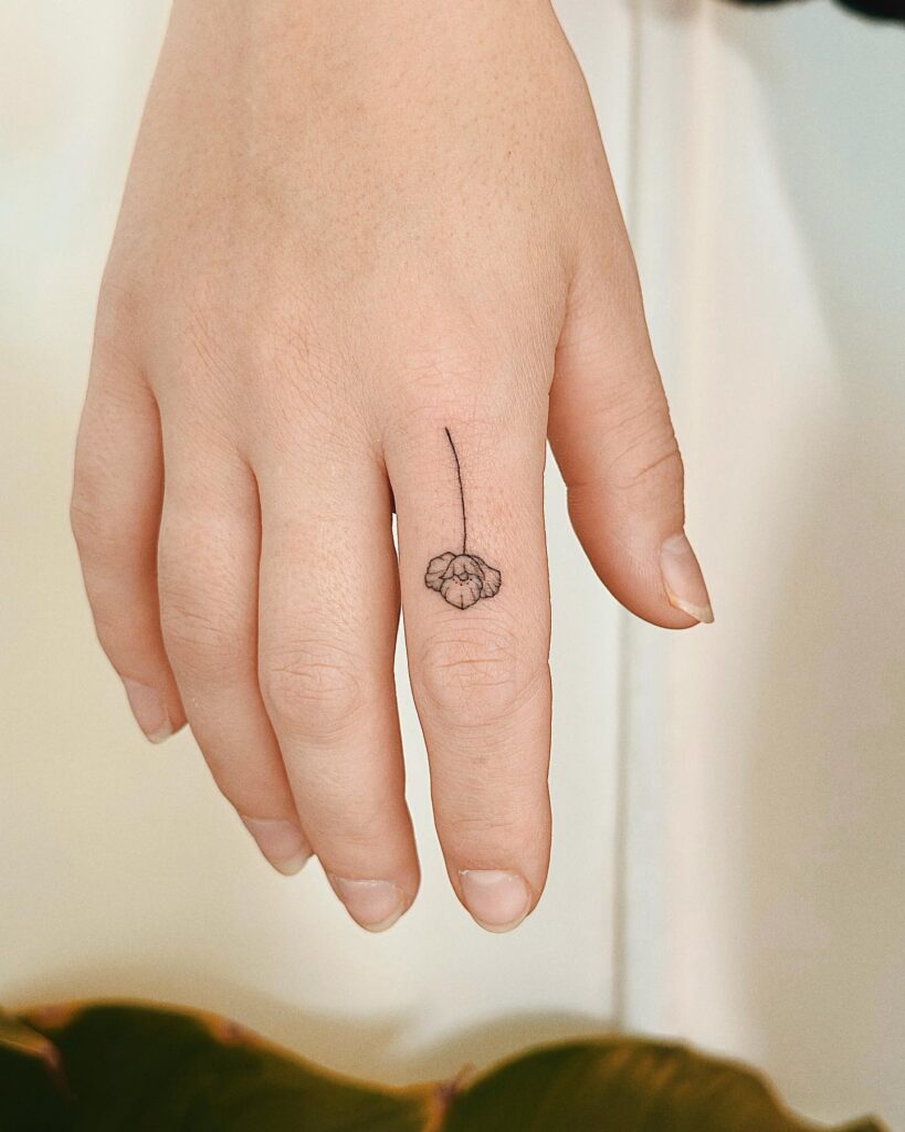 Mini flower tattoo on the forefinger finger flora