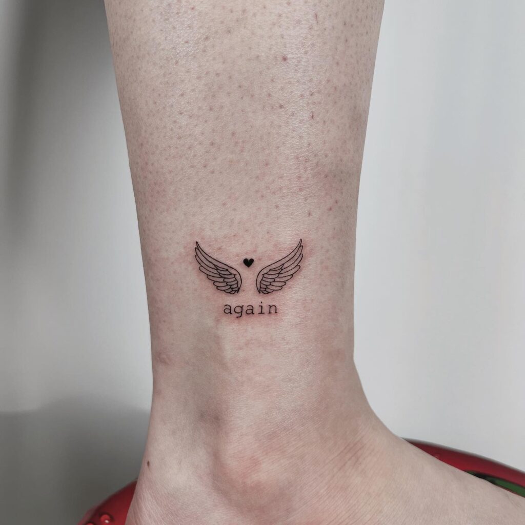 Mini Wings Tattoo Above the Ankle with 'Again' Lettering and a Heart Accent: Tiny Rebirth