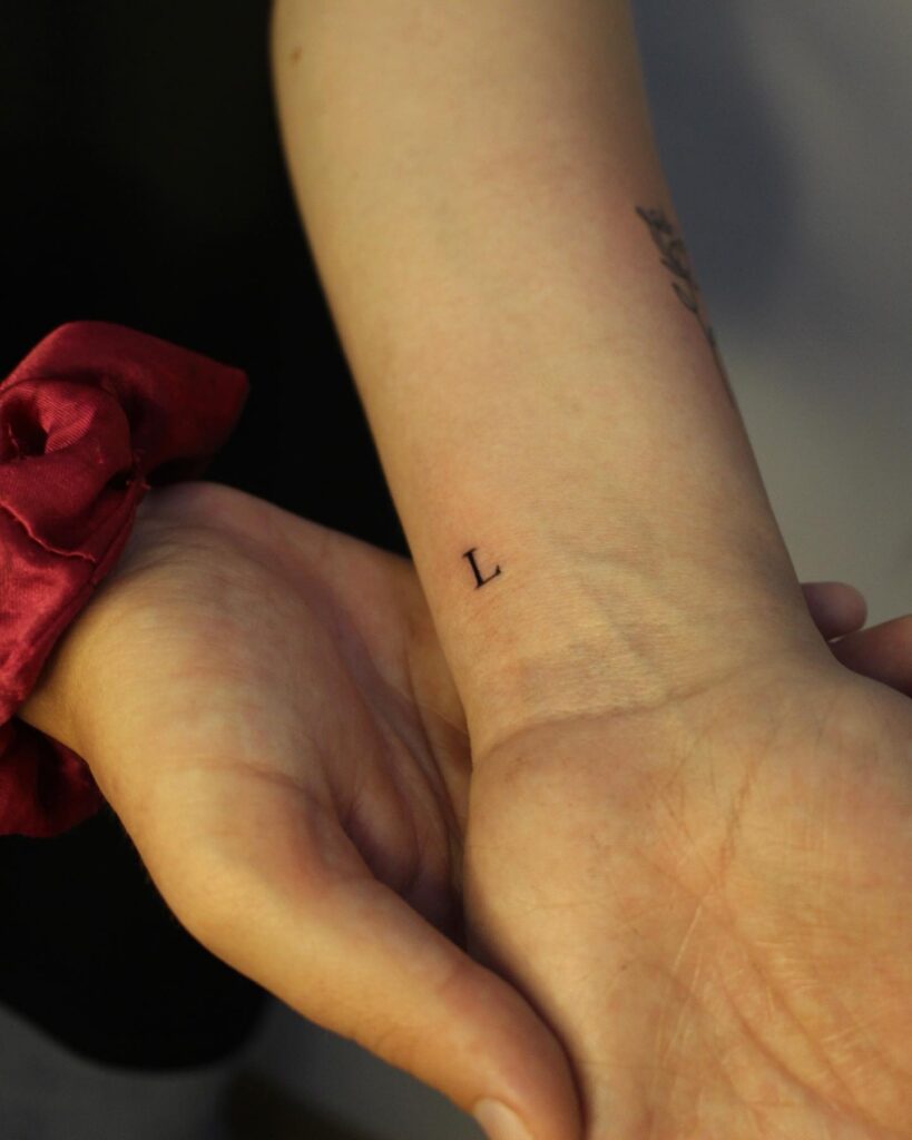 Minimal 'L' Letter Tattoo on the Side: Wrist Details