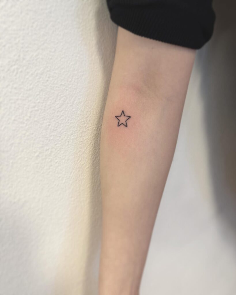 Minimal Outline Star Tattoo on the Forearm: Stellar Simplicity