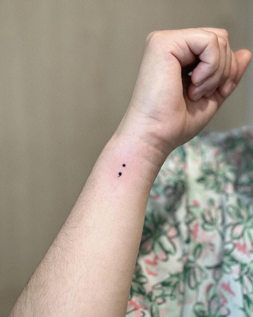 Minimal semicolon tattoo on the side wrist hopeful pause