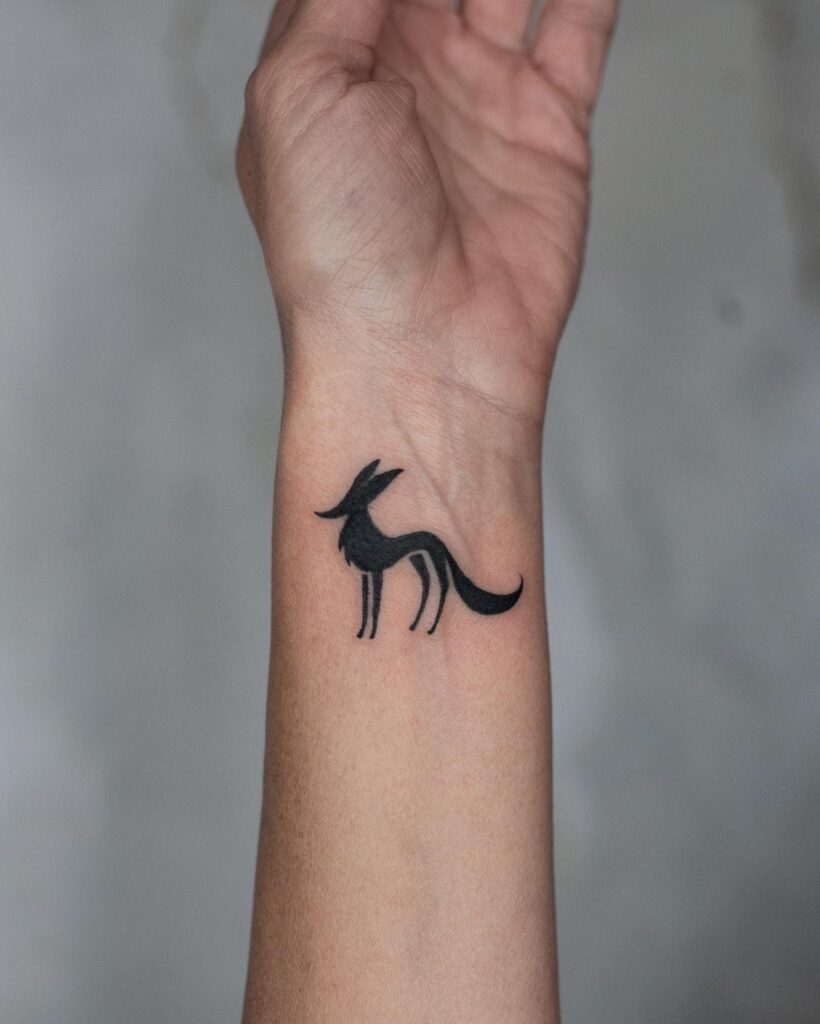 Minimal Side View Fox Tattoo Filled with Bold Black Color: Wrist Whimsy