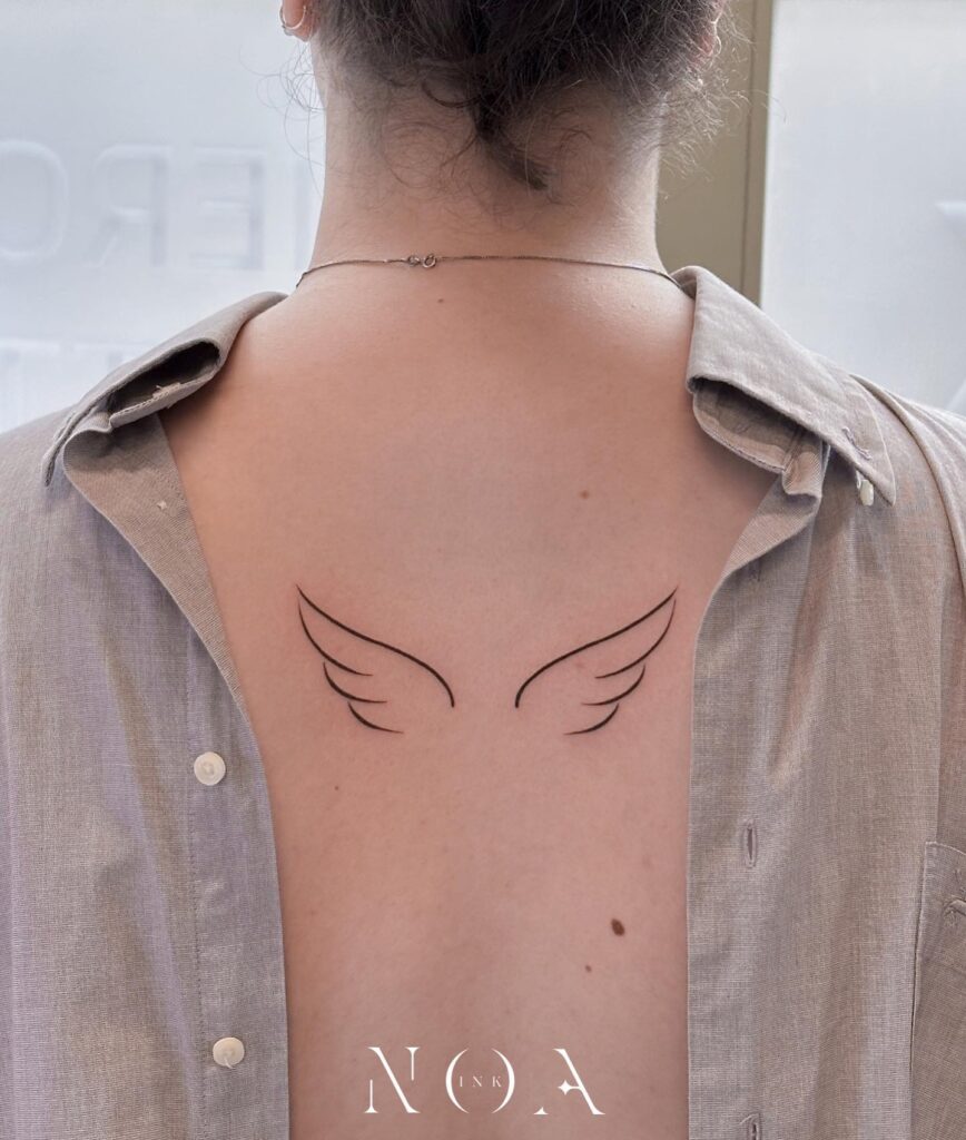Minimal Wings Outline Tattoo on the Back for a Clean and Simple Look: Subtle Soar