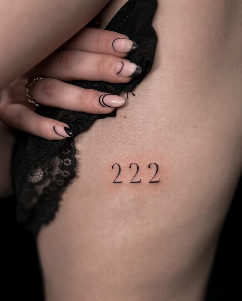 Minimalist '222' Tattoo on the Rib for Females, a Subtle Symmetry: Ribbons of Two 
