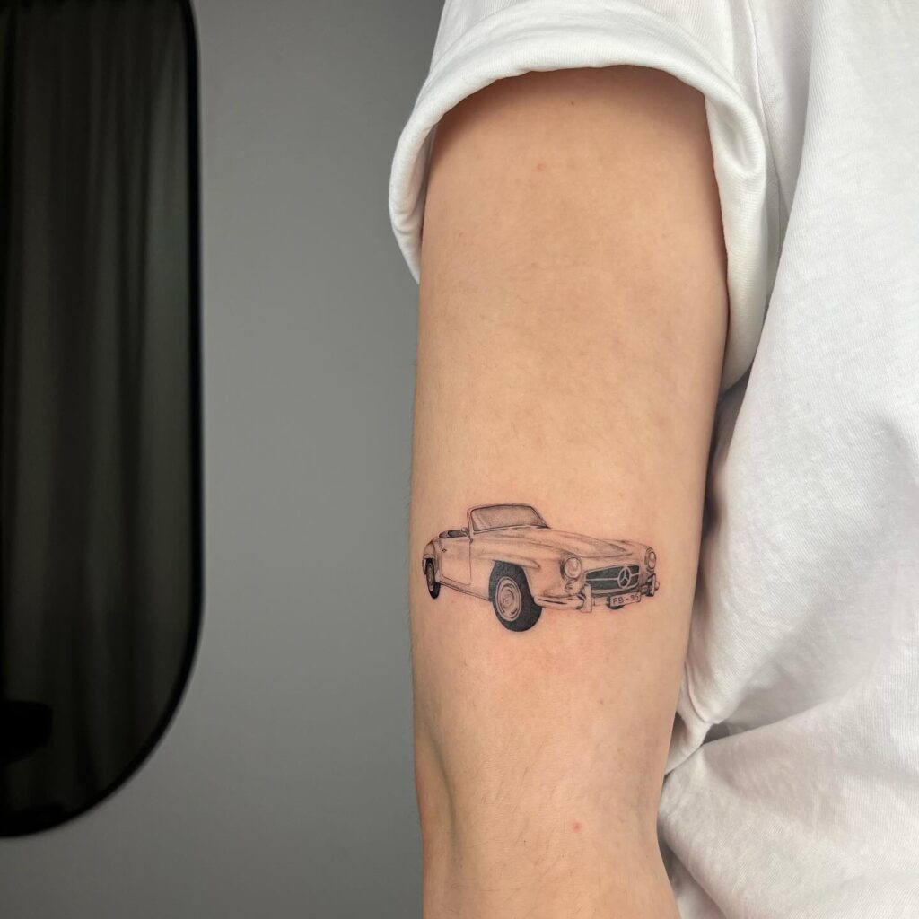 Minimalist Black and Gray Mercedes 190 SL Vintage Convertible Tattoo on Inner Upper Arm – Car Tattoo Ideas