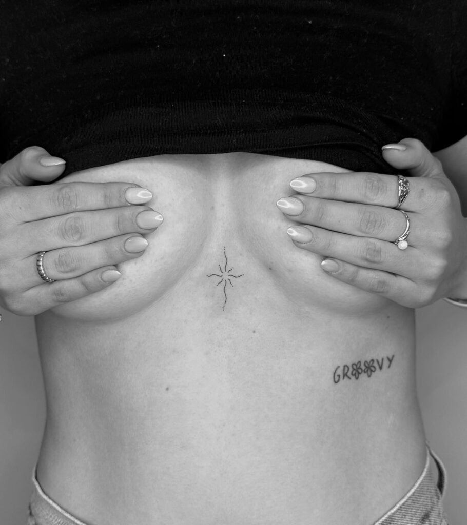 Minimalist celestial starburst sternum tattoo ideas