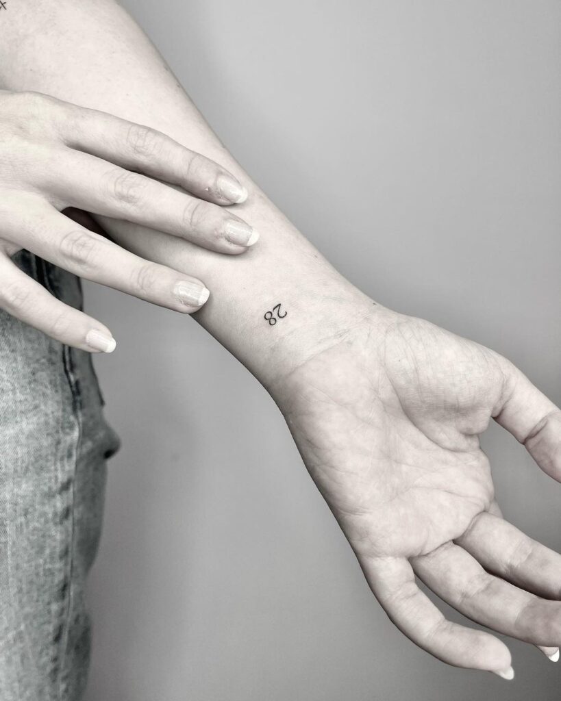 minimalist charm 28 mini number tattoo on the inner wrist