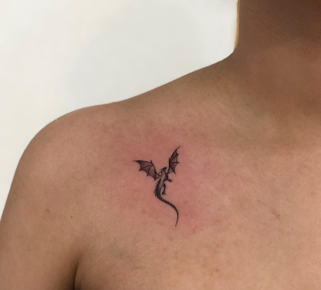 Minimalist dragon tattoo on the collarbone, a mythical mark of elegance dragon whispers