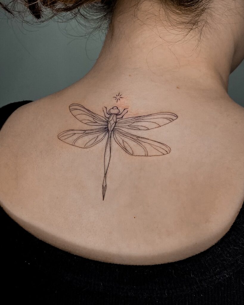 Minimalist Dragonfly Tattoo on Nape with Starburst Accent