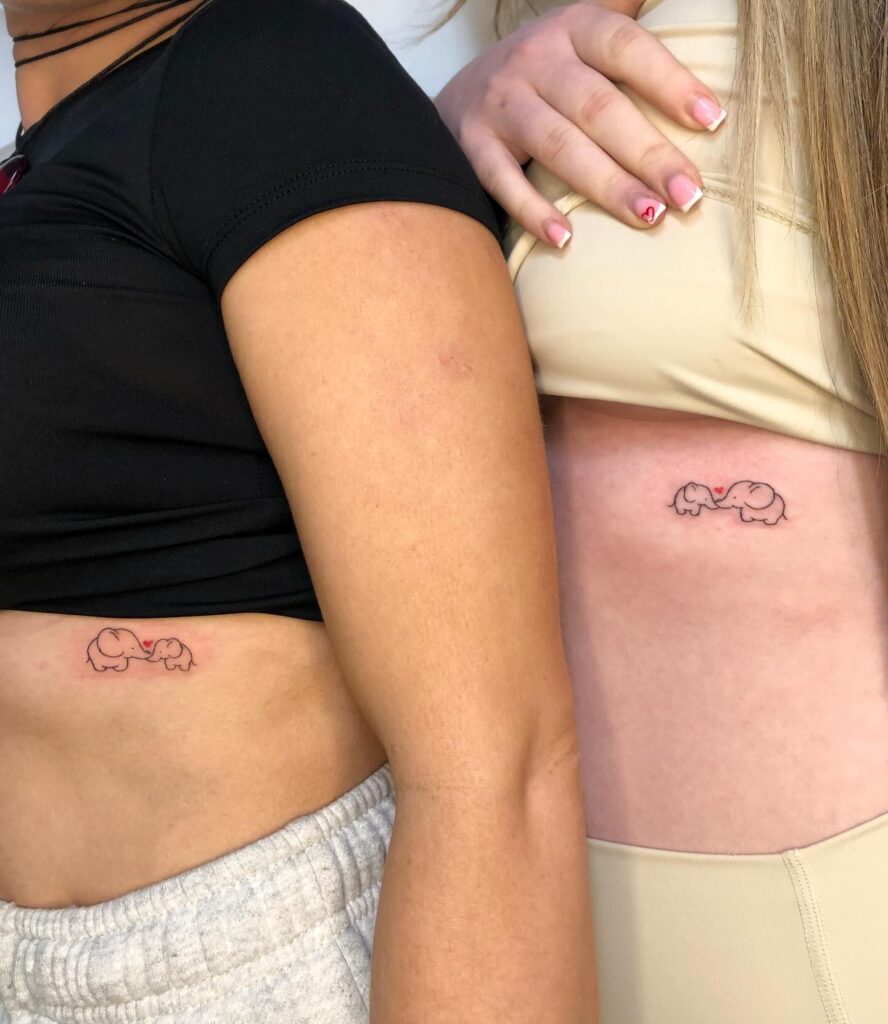 Minimalist elephant tattoos for mother and daughter that symbolize love and protection