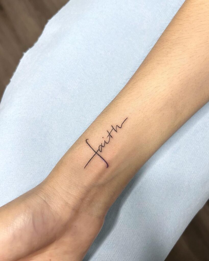 Minimalist faith script tattoo on inner wrist inner strength