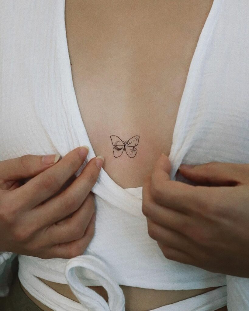 Minimalist fine-line butterfly sternum tattoo for transformation and freedom
