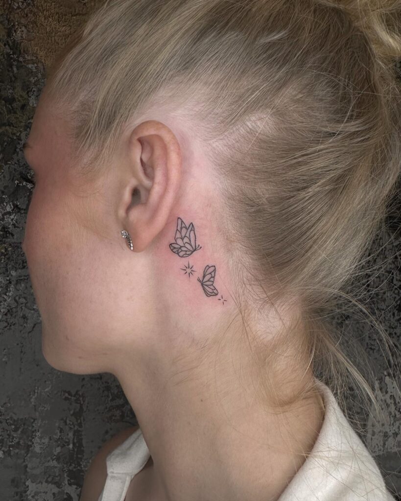 Minimalist fine line delicacy two small butterflies tattoos