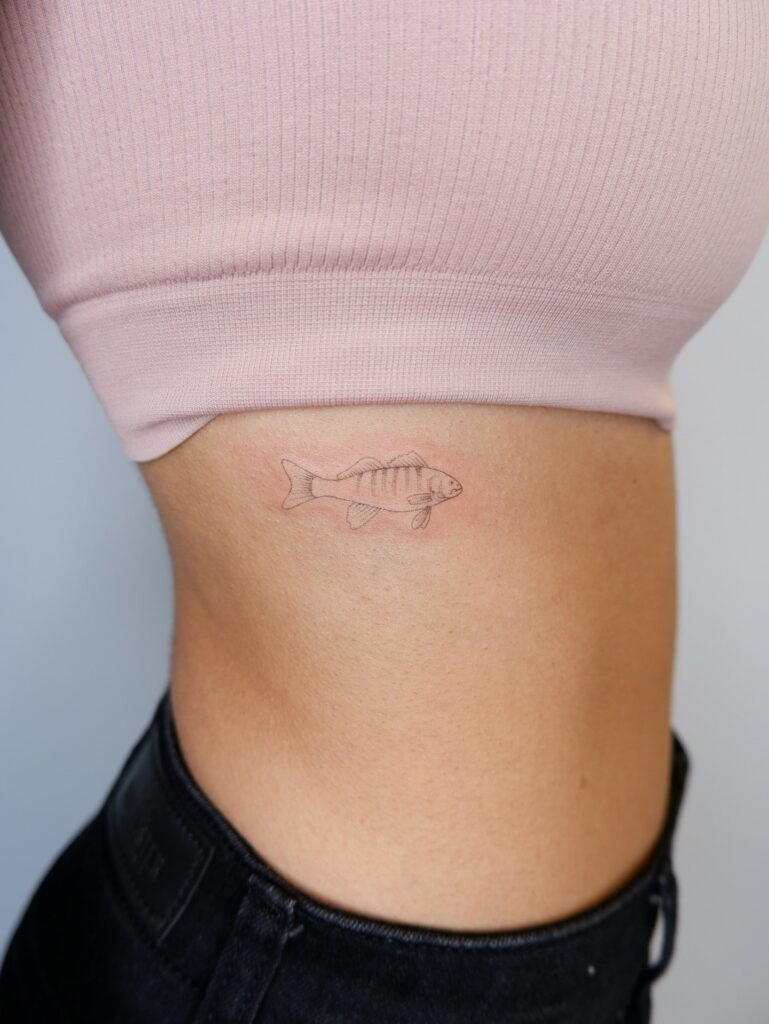 Minimalist Fish Tattoo with Rib Pattern: Rhythmic Patterns