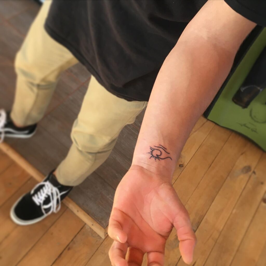 Minimalist Hand Tattoos: Sun and Wave Symbolism for Men