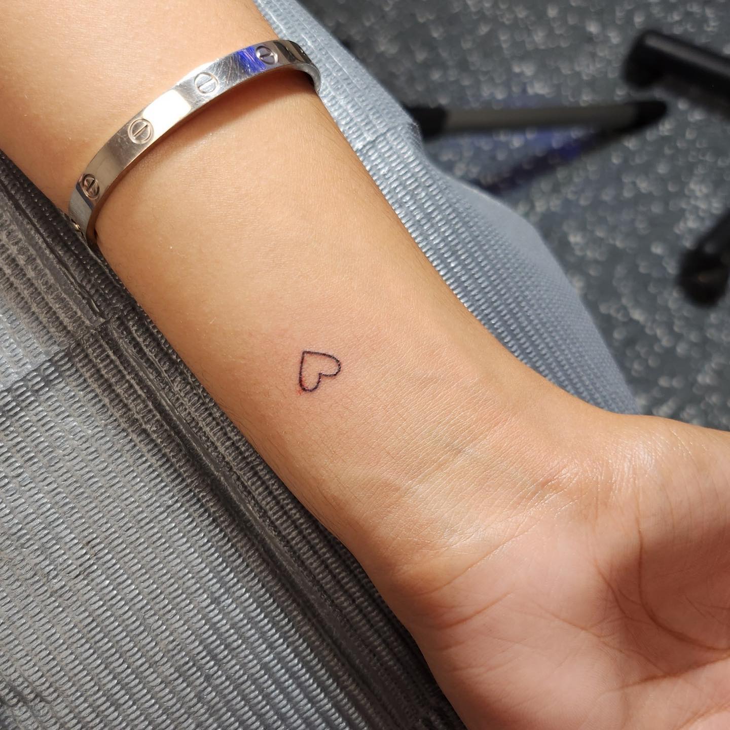 Minimalist Heart Outline Wrist Tattoo for Women Symbolizing Love and Self-Care
