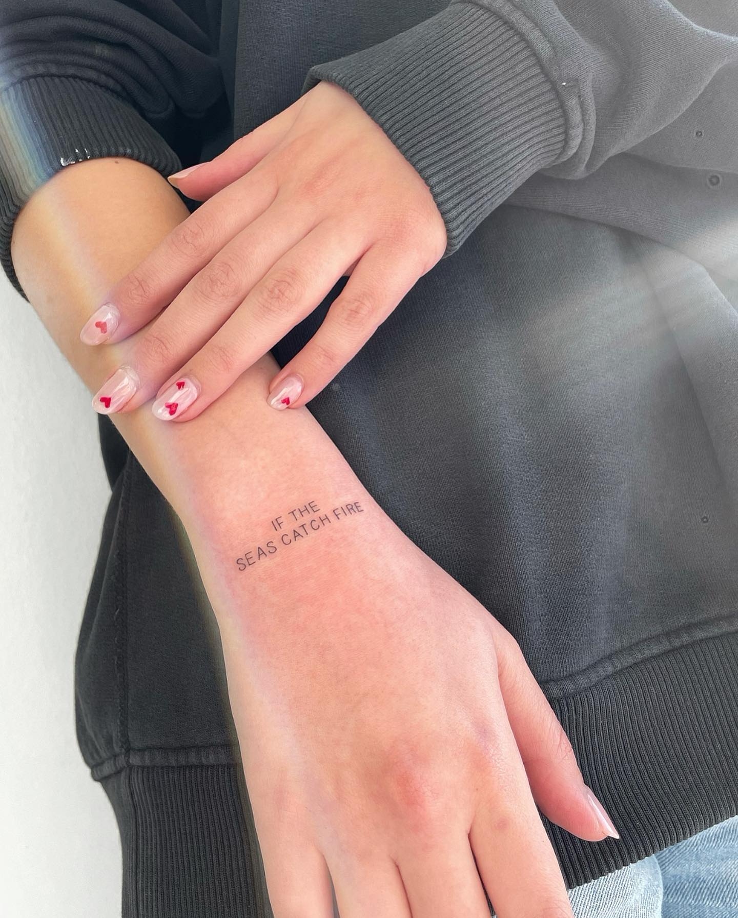 Minimalist 'IF THE SEAS CATCH FIRE' Text Tattoo Inspirational & Impactful