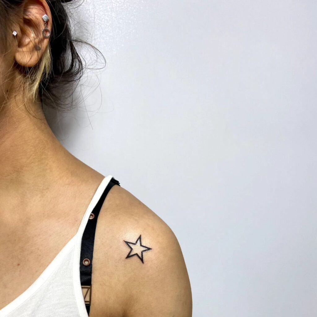 Minimalist magic outline single star tattoo for a small shoulder design