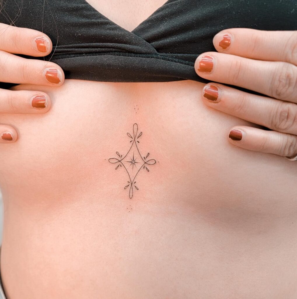 Minimalist ornamental sternum tattoo with geometric elegance