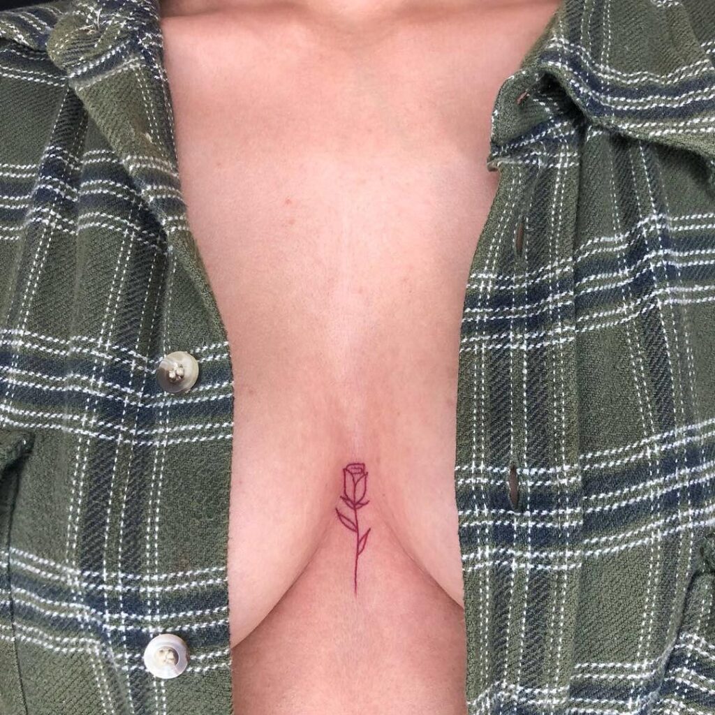 Minimalist rose chest tattoo representing love, beauty, and resilience