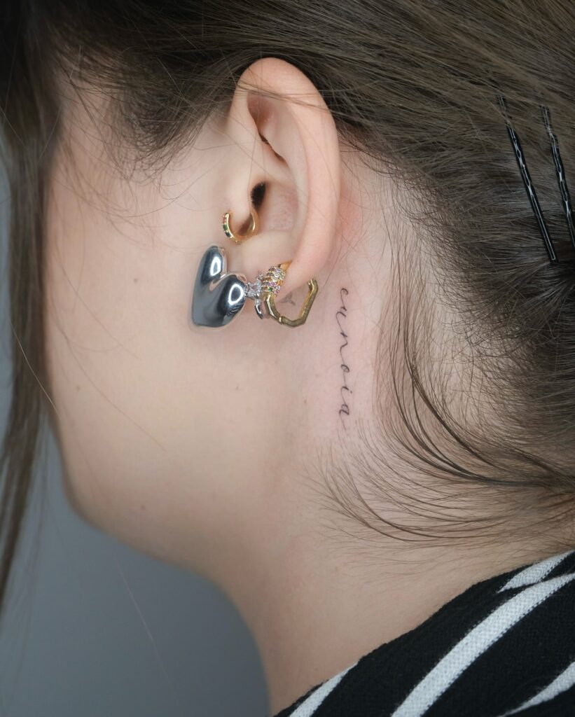 Minimalist Script Tattoo Behind Ear Subtle Elegant and Personal