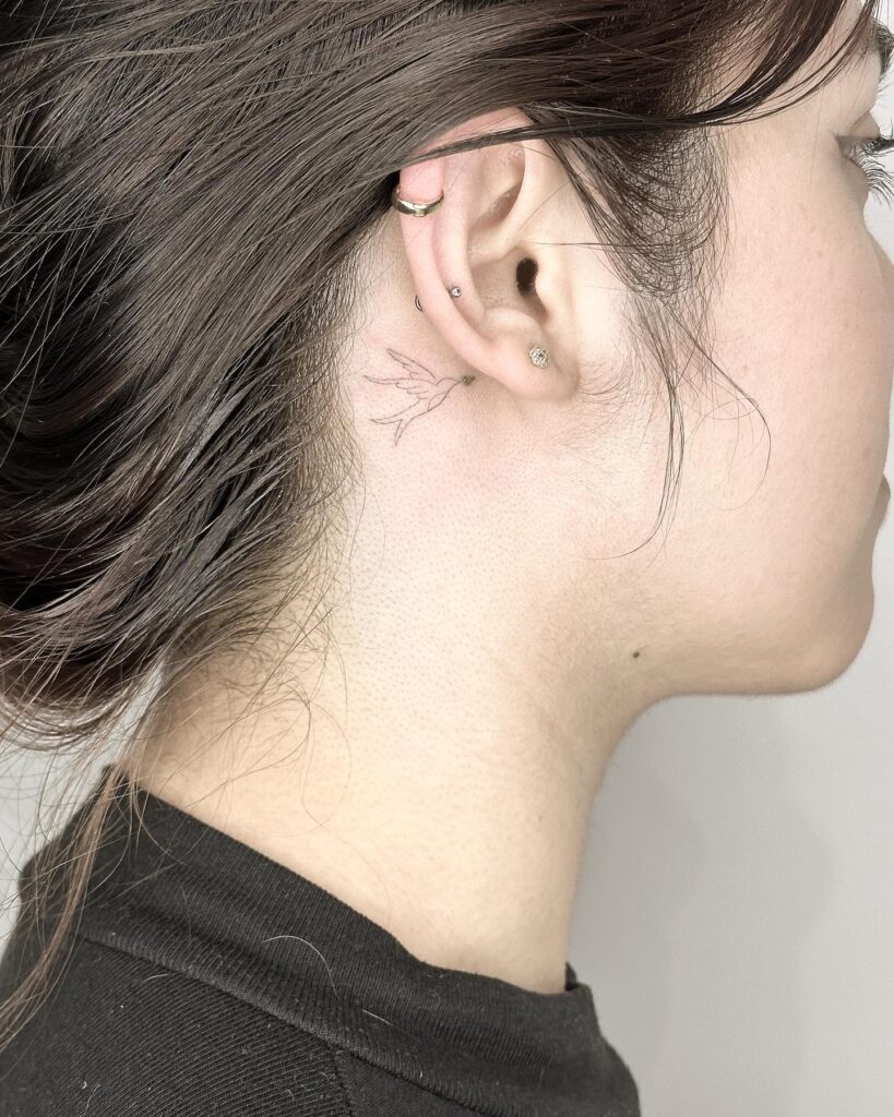 Minimalist Small Bird Tattoo Behind the Ear: Earside Tweet
